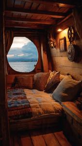 a bed in a room with a view of the ocean at Komodo Island in Ruda