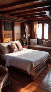 a bedroom with a large bed in a room at Komodo Island in Ruda
