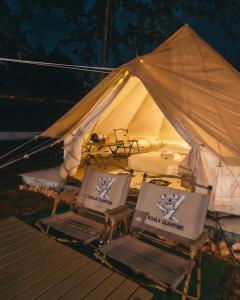 two chairs in front of a tent at night at Koala Glamping Krabi in Krabi