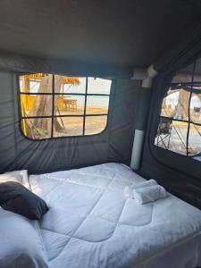 a bed in a small room with two windows at Koala Glamping Krabi in Krabi +21 photos