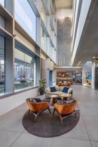 a lobby with a couch and chairs in a building at art'otel cologne in Cologne