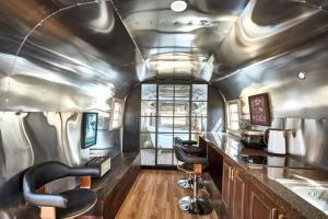 a kitchen with two chairs and a sink in a train at Out of Park in Chuncheon