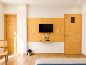 a room with a wall with a tv on it at The Grand Uddhav - a botique hotel in Udaipur