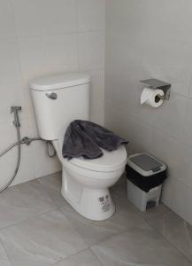 a bathroom with a toilet with a black jacket on it at Koala Glamping Krabi in Krabi
