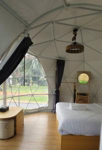 a room with a tent with a bed and a table at Koala Glamping Krabi in Krabi