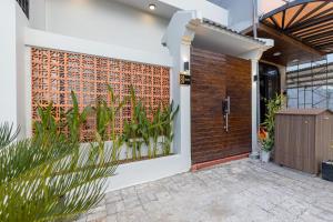 a front door of a house with a brick wall at Fusia Hotel & Apartment in Danang