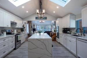 a kitchen with white cabinets and a marble counter top at Sun Drenched Lakefront Cove in Monticello