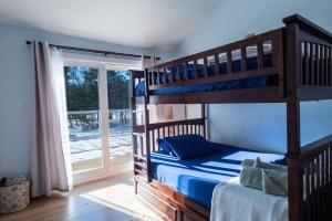a bedroom with two bunk beds and a sliding glass door at Sun Drenched Lakefront Cove in Monticello