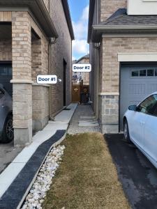 two street signs on the side of a house at New 2BR Central AC Laundry Private Entry Parking in Milton