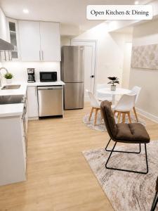 an open kitchen and dining room with a table and chairs at New 2BR Central AC Laundry Private Entry Parking in Milton