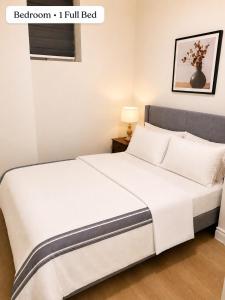 a bedroom with a bed with a white bedspread at New 2BR Central AC Laundry Private Entry Parking in Milton