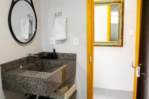a bathroom with a sink and a mirror at Sitio da Paz Celestial in Nova Petrópolis +25 photos