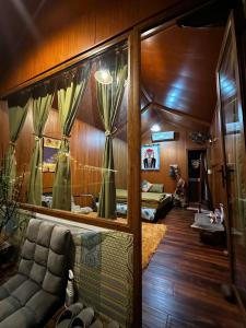 a living room with a couch and a mirror at An's House homestay & Hagiang local tours in Ha Giang