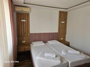 a bedroom with a bed with two towels on it at Villa Diana Self check-in in Kiten