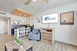 a living room with a blue chair and a table at Amazing Large Private Studio Condo with Amazing View in Myrtle Beach