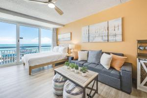 a living room with a bed and a couch at Amazing Large Private Studio Condo with Amazing View in Myrtle Beach