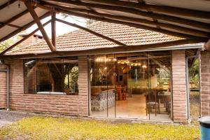 a glass extension to a house with a patio at Sitio da Paz Celestial in Nova Petrópolis