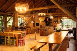 a kitchen and dining room with a wooden table at Sitio da Paz Celestial in Nova Petrópolis