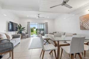 a living room with a table and chairs at Villa 3 Beach Front Tangalooma in Tangalooma
