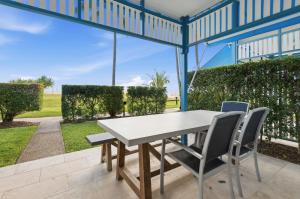 a table and chairs on the patio of a house at Villa 3 Beach Front Tangalooma in Tangalooma
