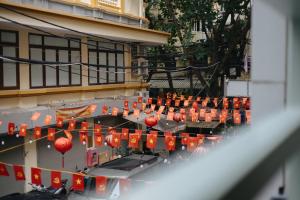 a bunch of red lanterns hanging from a building at Anchie Maison Hà Nội in Hanoi