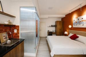 a bedroom with a bed and a glass shower at Anchie Maison Hà Nội in Hanoi +63 photos