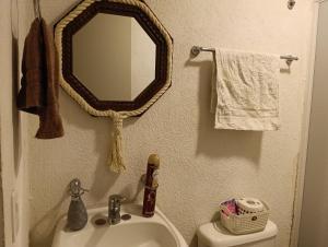 a bathroom with a sink and a mirror on the wall at Meraki in Guadalajara
