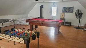 a living room with a pool table and a chessboard at Lakefront Suite with Geodesic Dome Experience in Stouffville