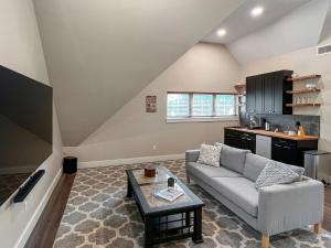 a living room with a couch and a table at Lakeside Lodge with Studio Apartment in Monticello