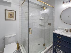a bathroom with a shower with a toilet and a sink at Lakeside Lodge with Studio Apartment in Monticello +45 photos