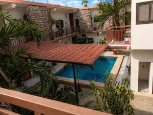 an external view of a hotel with a swimming pool at Sunset Suites in Brisas de Zicatela