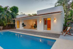 a villa with a swimming pool in front of a house at Casa Brasil Careyes in Careyes +37 photos