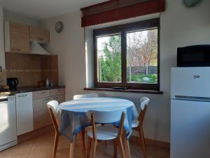 a kitchen with a table and chairs and a window at Lazdas in Saulkrasti
