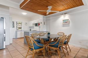 a kitchen and dining room with a table and chairs at Villa 30 Tangalooma in Tangalooma