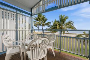 a table and chairs on a balcony overlooking the beach at Villa 30 Tangalooma in Tangalooma +12 photos