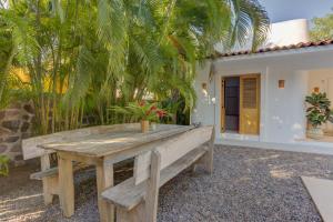 a wooden bench sitting in front of a house at Casa Brasil Careyes in Careyes
