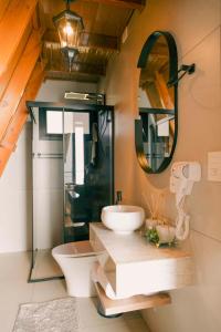 a bathroom with a sink and a mirror at Cabanas Monte Cristo in Serafina Corêa +12 photos