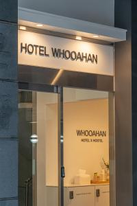 a sign for a hotel whooganian on a building at Hotel Whooahan Suyu in Seoul