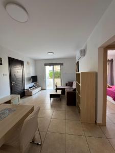 a living room with a couch and a table at Amigos Apartment Mythical in Protaras