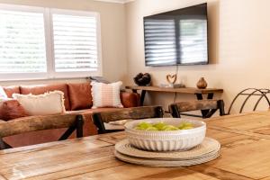 a dining room table with a bowl of apples on it at Ovens River Retreat in Harrietville