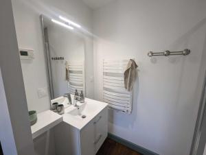 a white bathroom with a sink and a mirror at L'ecole buissonnière in Riaucourt +28 photos