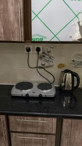 a stove top on a counter in a kitchen at صالة المدينة 2 in Medina