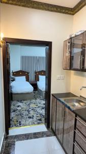 a kitchen with two beds in a room at صالة المدينة 2 in Medina