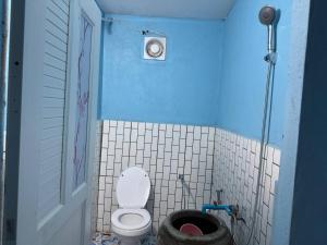 a bathroom with a toilet in a blue room at Chamka Sne LyLy Resort in Phumĭ Stœ̆ng Chral +67 photos