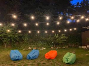 three bean bags sitting in the grass under lights at Yangyang Dalpaengi Pension in Yangyang