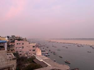 a view of a river with boats in it at Kashiyana in Varanasi