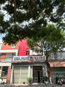 a building with a sign that reads nma new homes at Nhà Nghỉ Hoa Lan2 in Buon Ma Thuot