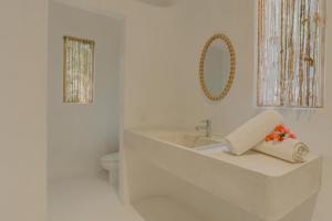 a white bathroom with a sink and a toilet at Casa Brasil Careyes in Careyes