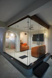 a room with a glass case with a bed in it at TheCloud Hotel in Nizāmābād