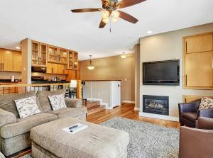 a living room with a couch and a fireplace at Crestview Place Mountain View Balcony & Shuttle in Winter Park